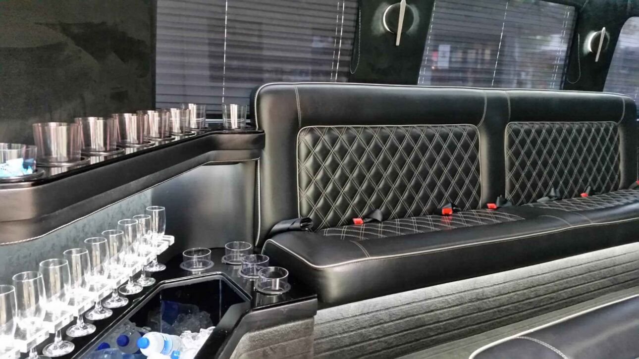 Luxurious limo interior with black leather seats. Sleek, sophisticated ambiance.