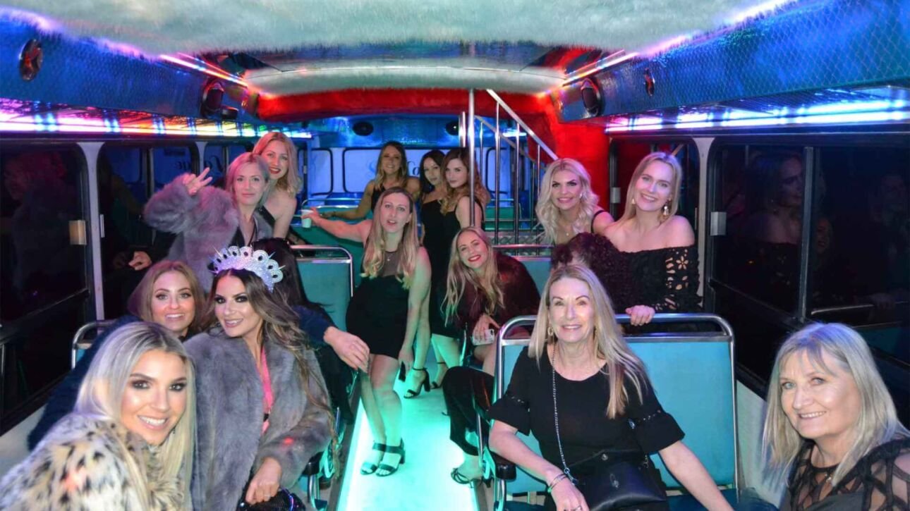 A large group of women posing inside a party bus during a hen party.