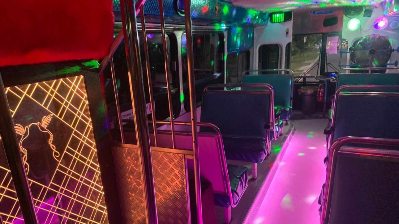 The colorful interior of Party Charter Perth's Sky Lounge, a 37-seater white blue party bus.