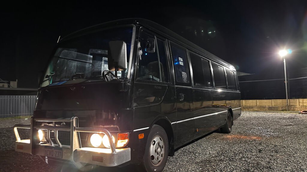 The exterior of Party Charter Perth's Mini Bus, a 23-seater black party bus.