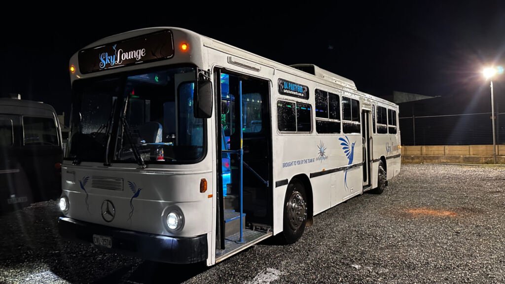 The exterior of Party Charter Perth's Sky Lounge, a 37-seater white blue party bus.
