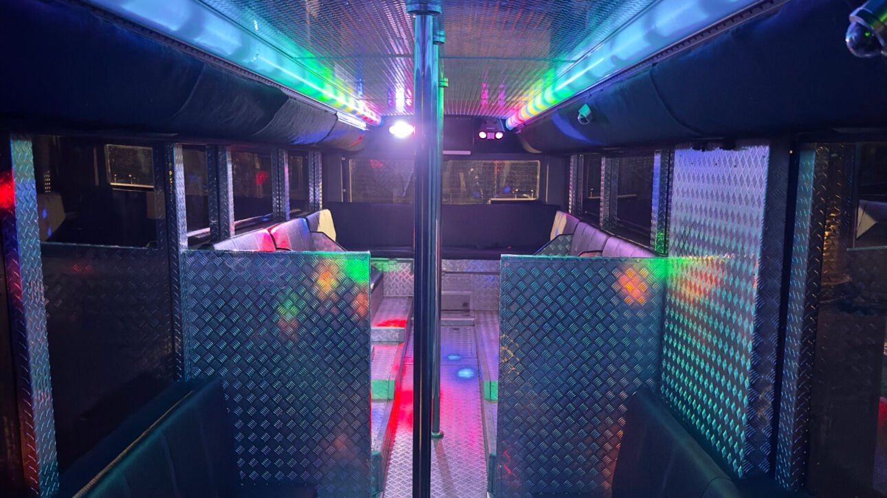 The interior of Party Charter Perth's Limobus, a 45-seater black party bus.