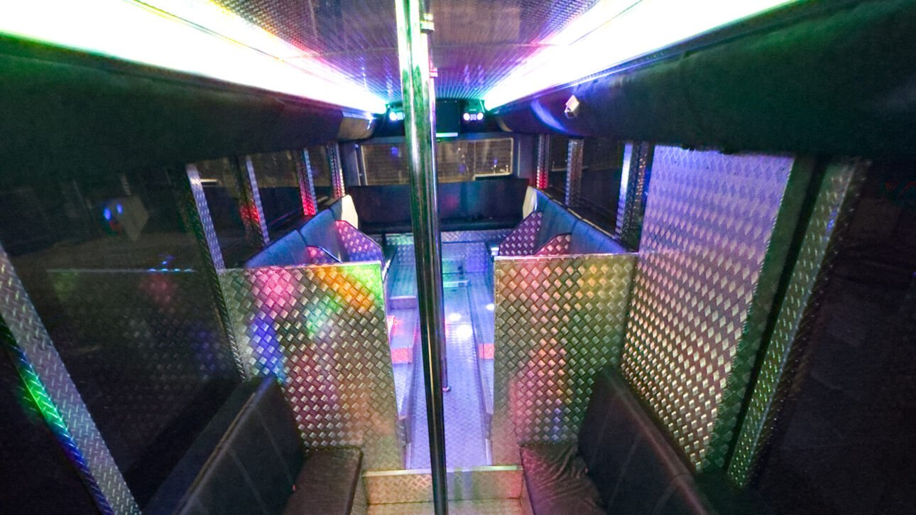The interior of Party Charter Perth's Limobus, a 45-seater black party bus.
